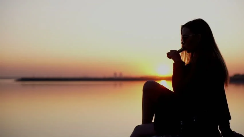 person vaping in Dubai traffic Burj Khalifa, JBR beach vaping at sunset - Young Beautiful Woman Smoking Vaping E-cigarette